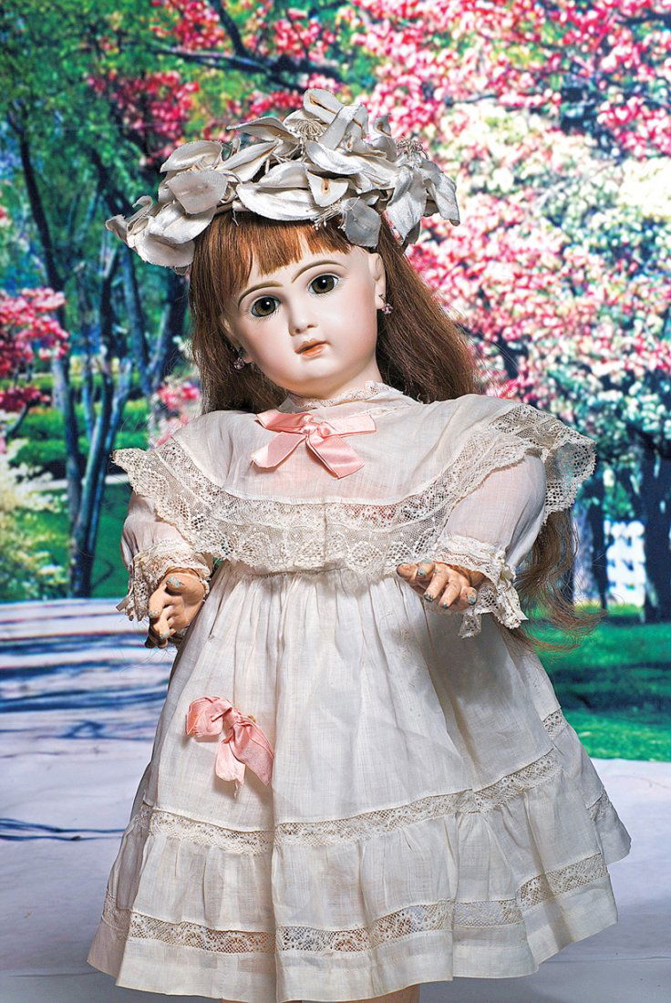 FRENCH BISQUE BEBE BY EMILE JUMEAU. Marks: Depose: FRENCH BISQUE BEBE BY EMILE JUMEAU. Marks: Depose Tete Jumeau Bte SGDG 10. 22”. Bisque socket head, brown paperweight eyes, painted lashes, eyeliner, feathered and brushstroked brows, pierced ears,