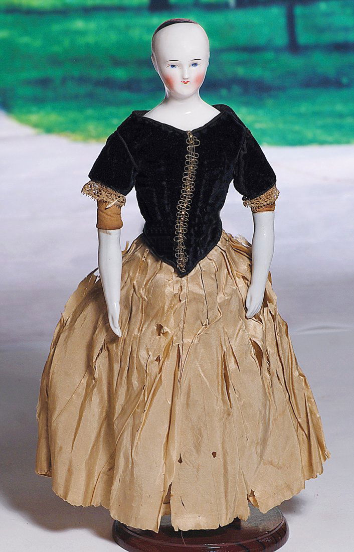 FINE GERMAN CHINA LADY KNOWN AS BEIDERMEIER. 13 ½”.: FINE GERMAN CHINA LADY KNOWN AS BEIDERMEIER. 13 ½”. Porcelain shoulderhead with painted black pate, painted features, blue eyes, red and black lid lines, tapered brows, closed mouth with modelled w