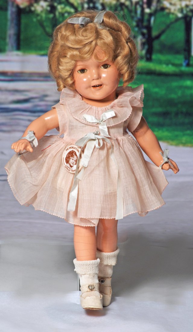 COMPOSITION SHIRLEY TEMPLE DOLL.: COMPOSITION SHIRLEY TEMPLE IN CURLY TOP DRESS. Marks: Shirley Temple 13. 13”. Composition socket head on five-piece jointed body, original blonde wig in original set, sleep eyes, applied and painted