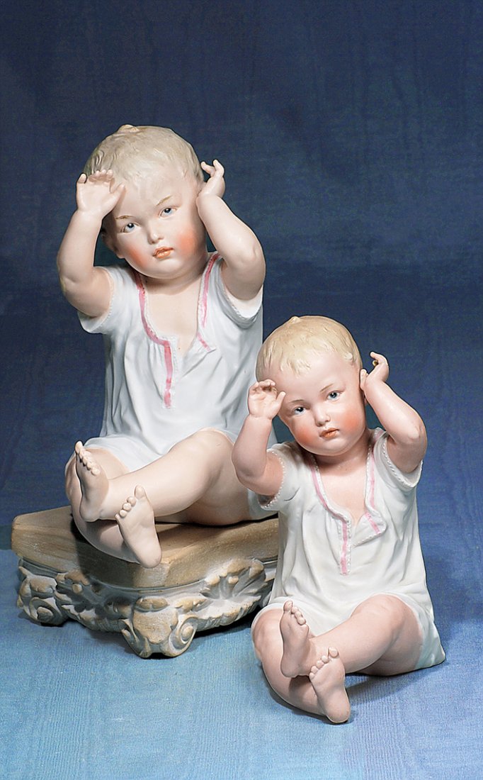 LARGE GERMAN BISQUE PIANO BABY BY GEBRUDER HEUBACH.: LARGE GERMAN BISQUE PIANO BABY BY GEBRUDER HEUBACH. Marks: incised numbers. 9 ½”. All-bisque figure of baby with character face, sculpted blonde hair, painted features, blue intaglio eyes, molded a