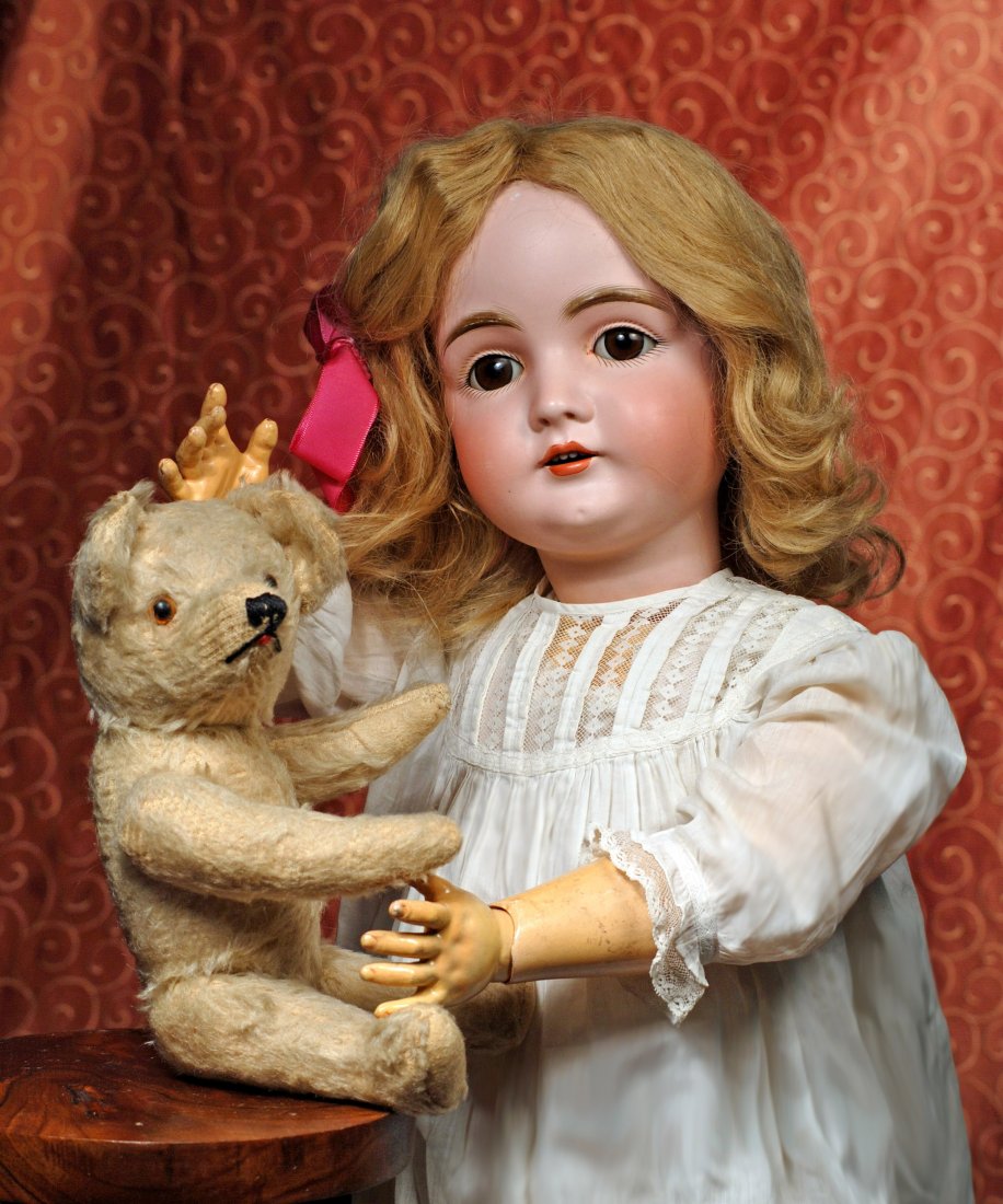 IVORY MOHAIR TEDDY BEAR: IVORY MOHAIR TEDDY BEAR. 11”. Ivory mohair bear has swivel neck, jointed limbs, amber glass eyes, floss nose and mouth, white felt paw pads, straw stuffing, large ears, upturned nose. Commentary: 19