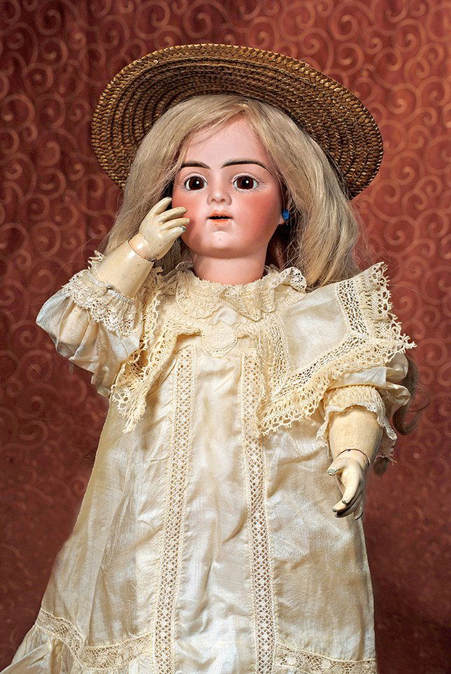 FRENCH BISQUE “BEBE BRU JNE R” WITH KISS-THROWING: FRENCH BISQUE “BEBE BRU JNE R” WITH KISS-THROWING MECHANISM. Marks: Bru Jne R 9. 22 ½”. Bisque socket head, brown paperweight eyes, painted lashes, feathered and brushstroked brows, pierced ear