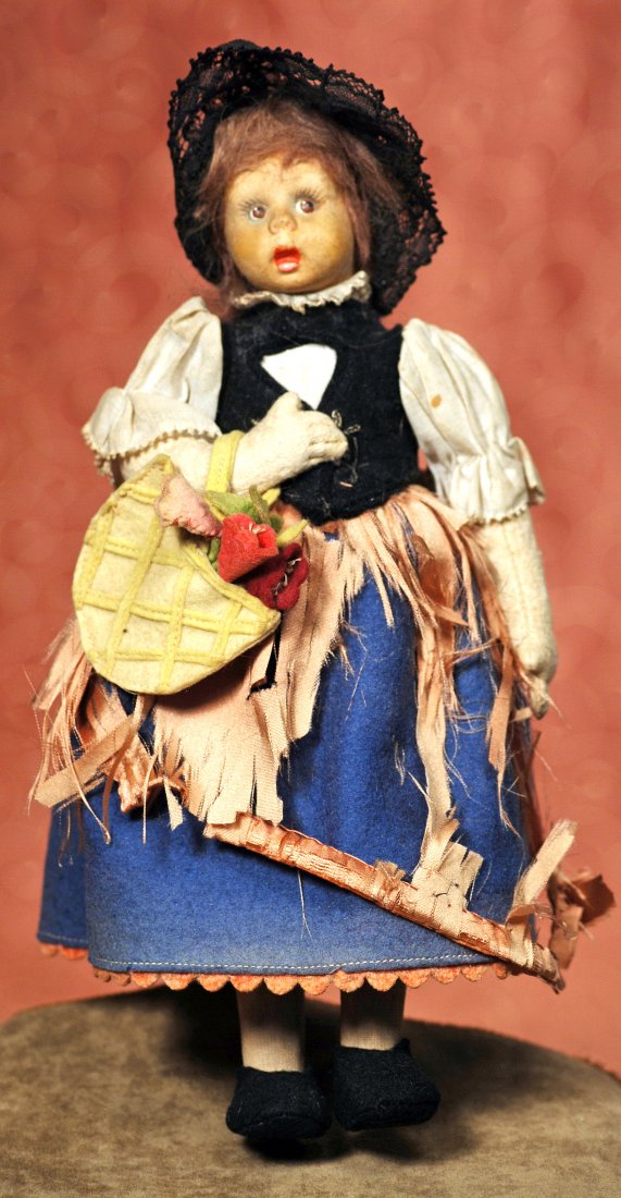 ITALIAN FELT MASCOTTE MINIATURE DOLL BY LENCI.: ITALIAN FELT MASCOTTE MINIATURE DOLL BY LENCI. 9”. Pressed felt head with painted features, cloth body with felt arms, jointed shoulders and hips, original mohair wig, original felt and cotton costu