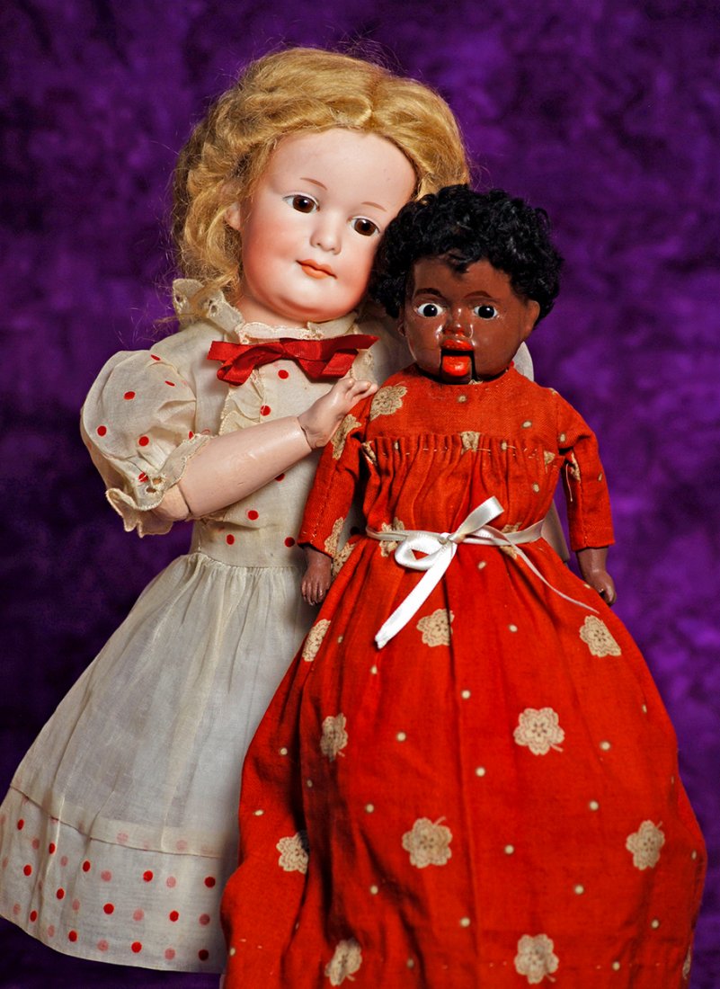 BLACK PAPIER MACHE NOVELTY DOLL.: BLACK PAPIER MACHE NOVELTY DOLL. 12”. Papier mache shouldehead, inset dark glass eyes, painted brows, red lips with painted upper teeth, black mohair wig, cloth body with painted brown composition l