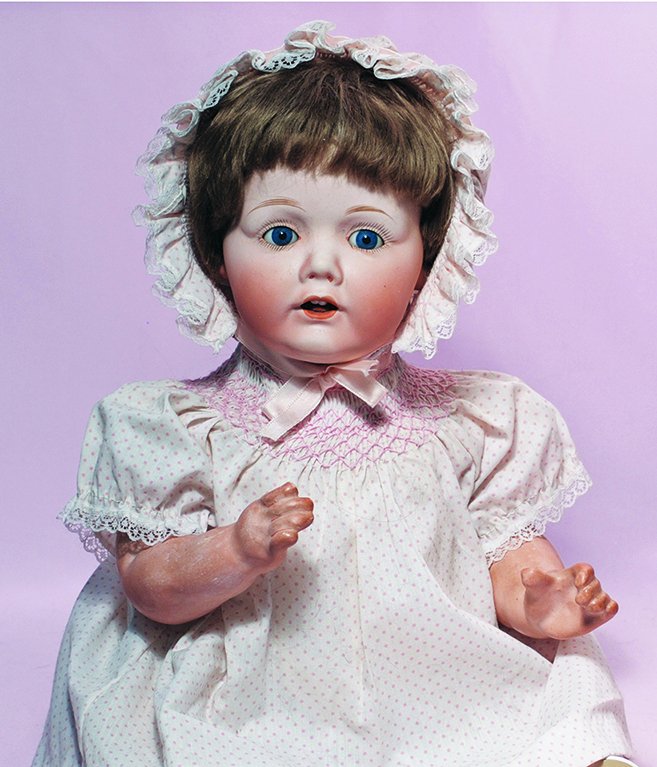 BISQUE HILDA-TYPE BABY BY NIPPON. 20”. Bisque socket: BISQUE HILDA-TYPE BABY BY NIPPON. 20”. Bisque socket head, stationary blue glass eyes, painted lashes, feathered brows, open mouth, upper teeth, composition baby body. Commentary: Good quality bisqu