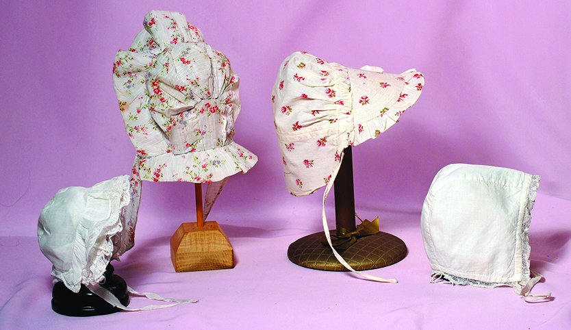 FOUR ANTIQUE DOLL BONNETS.  Two floral cotton print (1 of 1)