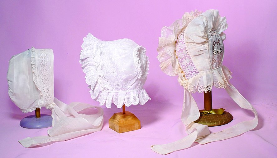 THREE ANTIQUE DOLL BONNETS.  White cotton bonnets with (1 of 1)
