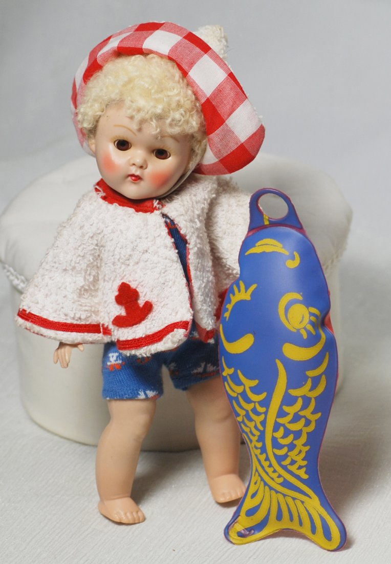 VOGUE POODLE-CUT GINNY IN BEACH OUTFIT. 8”. Hard: VOGUE POODLE-CUT GINNY IN BEACH OUTFIT. 8”. Hard plastic, straight legs, brown sleep eyes, painted lashes, blonde poodle-cut wig, tagged blue knit sail boat patterned swim suit, white terry cloth ja