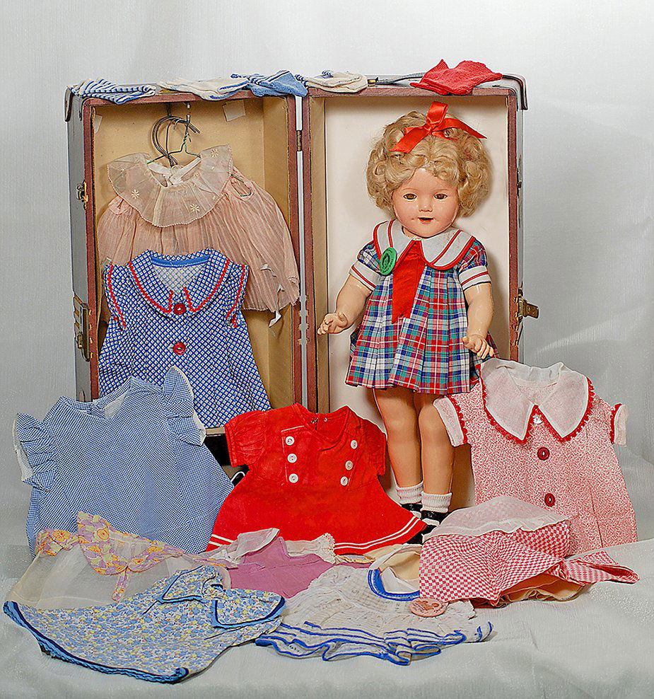 COMPOSITION “SHIRLEY TEMPLE” BY IDEAL WITH TRUNK AND: COMPOSITION “SHIRLEY TEMPLE” BY IDEAL WITH TRUNK AND WARDROBE. Marks Shirley Temple copr. Ideal N & T (head); Shirley Temple 18 (body). 18”. Composition socket head on five-piece jointed composi