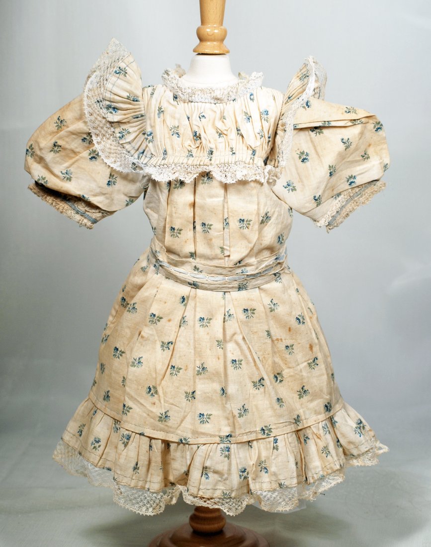 ORIGINAL FACTORY CHEMISE BY JUMEAU. 6” shoulder width,: ORIGINAL FACTORY CHEMISE BY JUMEAU. 6” shoulder width, 16” length. Cream muslin presentation chemise dress with dainty blue flowers, fluted yoke with lace edging, original belt, pleated skirt ruff