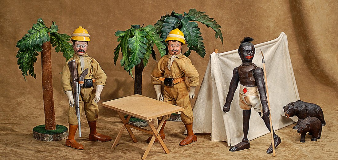 SCHOENHUT TEDDY SAFARI NATIVE GUIDE.8”.Carved wooden: SCHOENHUT TEDDY SAFARI NATIVE GUIDE.8”.Carved wooden jointed figure with dark complexion and musculature carved torso, leather ears, painted features, wearing original cotton print shorts and sash, 