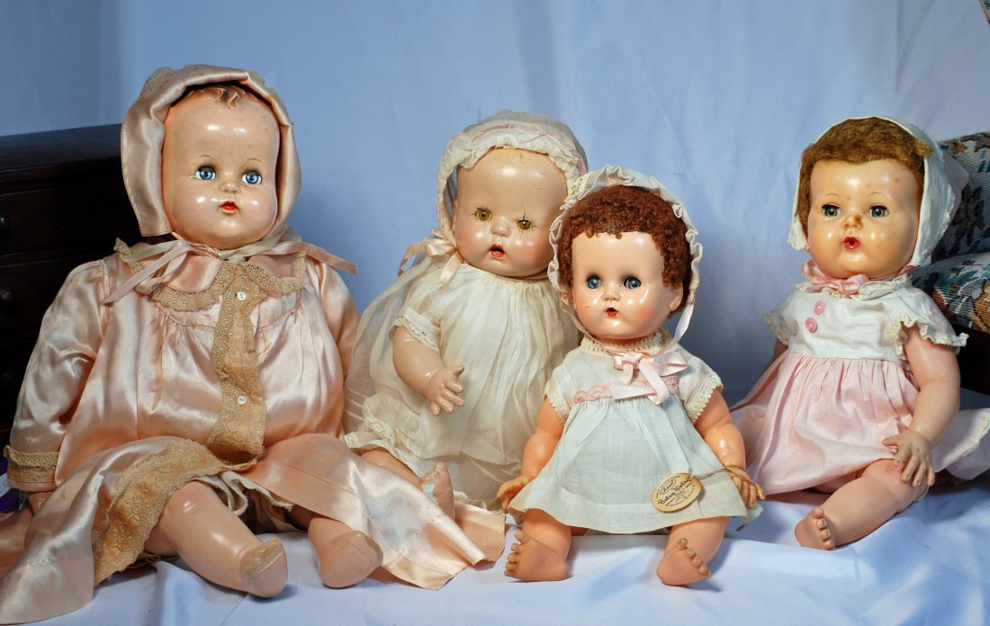 FOUR COMPOSITION AND PLASTIC BABY DOLLS. (1 of 1)