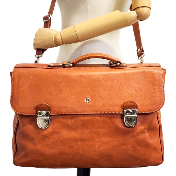 Vintage VALENTINA Dark Tan Leather Briefcase/Messenger/Travel Bag: Vintage Valentina Dark Tan Leather Briefcase/Messenger/Travel Bag. Silver tone buckle closure. Removable/adjustable leather crossbody strap. Exterior and interior pockets. Does NOT have a padded pocke