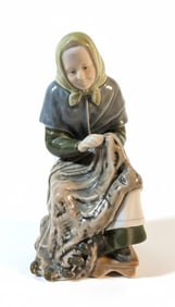 Porcelain Figurine of a Woman Carrying a Basket