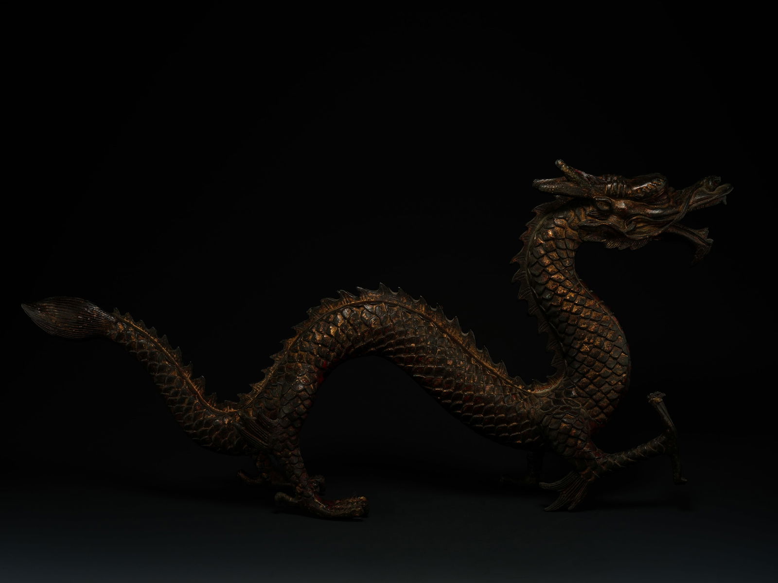 A Chinese Bronze Figure of a Striding Dragon. (1 of 4)
