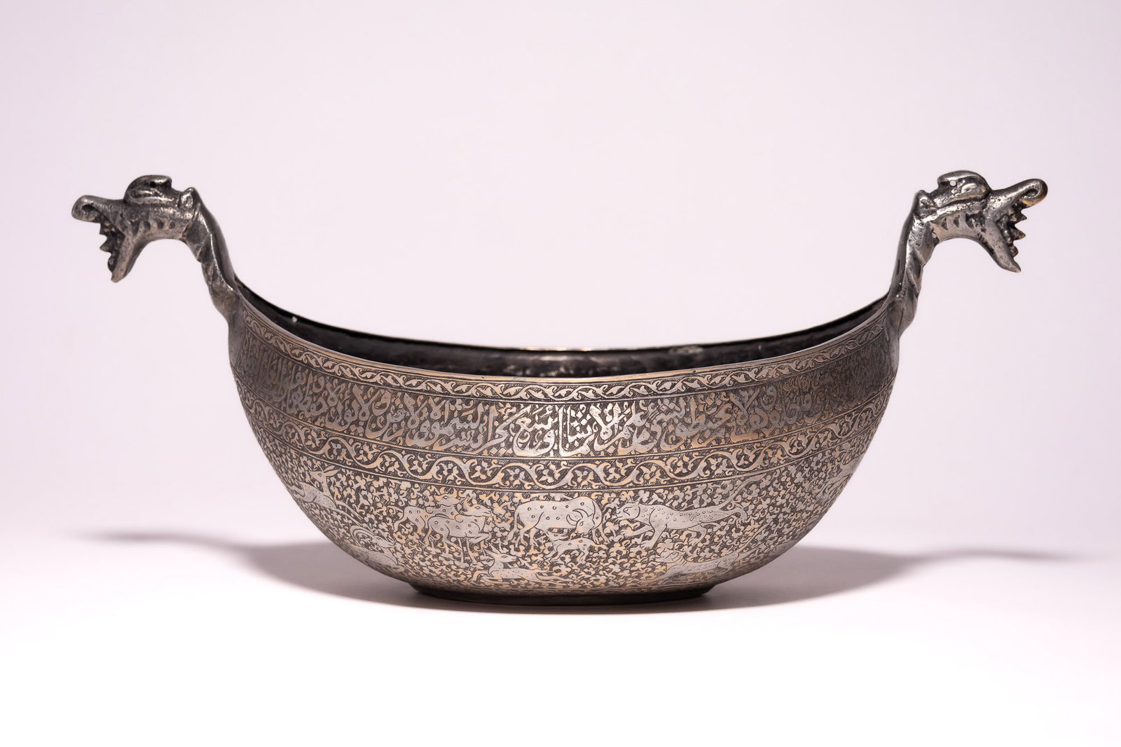 A PERSIAN QAJAR TINNED COPPER KASHKUL, 19TH CENTURY. (1 of 5)