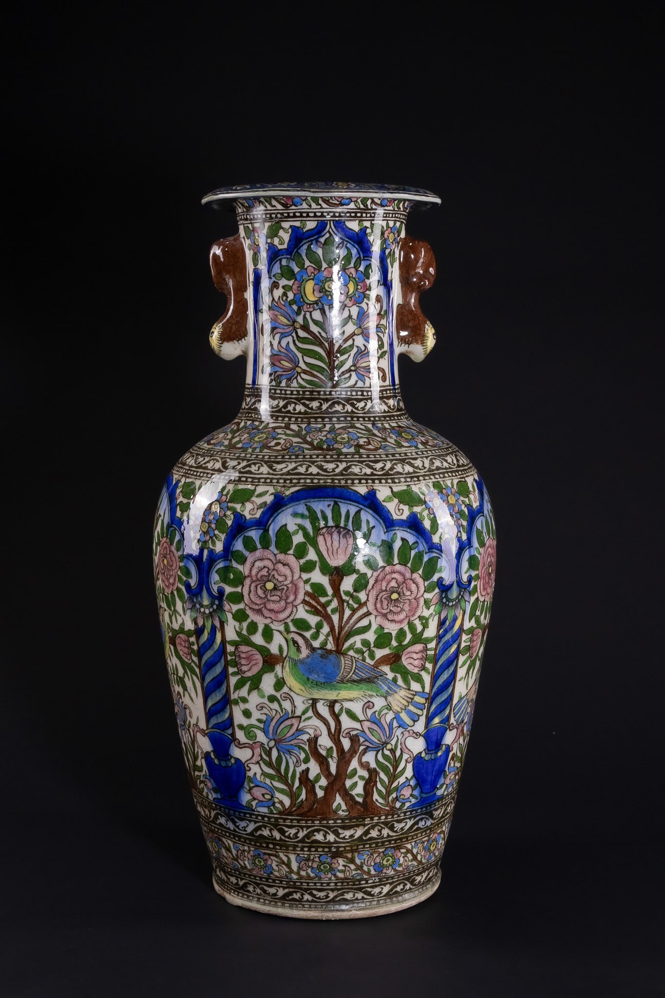 A QAJAR POLYCHROME ENAMELLED VASE WITH AVIAN AND FLORAL DECORATION, 19TH CENTURY.: A finely decorated Qajar ceramic vase of baluster form with a flared rim and short cylindrical neck, the body richly enamelled in vibrant tones of cobalt blue, emerald green, soft pink, yellow and bro
