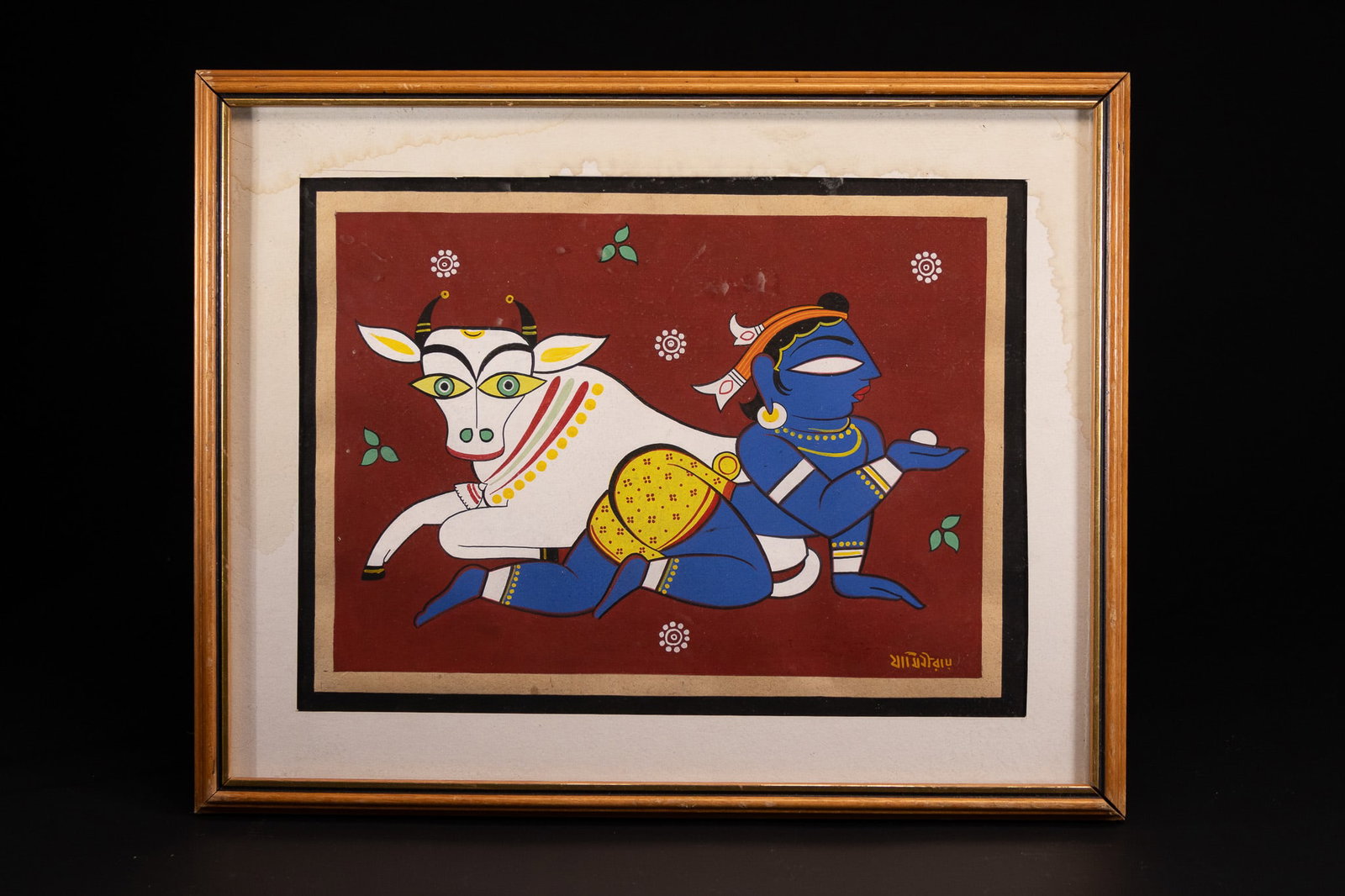 JAMINI ROY (INDIAN, 1887-1972) 'BALA KRISHNA AND COW' (SIGNED).: This work on paper, executed in gouache or tempera, depicts the deity Krishna as a child, traditionally identified as Bala Krishna. The figure is rendered with blue skin, shown crawling and holding a