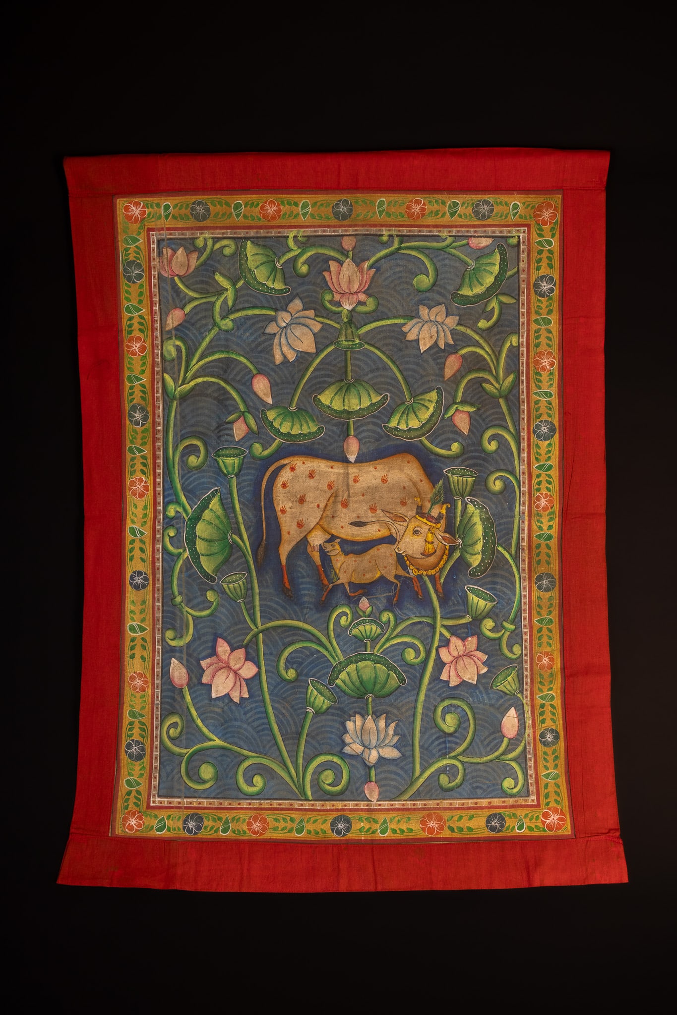 AN INDIAN NATHDWARA STYLE PICHWAI PAINTING OF A COW AND CALF IN A LOTUS POND, 20TH CENTURY. (1 of 1)