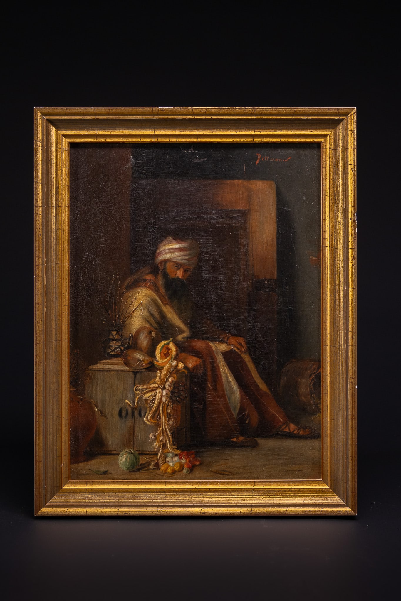 DETTMANN, ORIENTALIST SCENE WITH A MERCHANT AND MARKET PRODUCE.: This Orientalist oil on wood is signed Dettmann in red paint to the upper right corner. The composition depicts a bearded man wearing a striped turban and traditional robes, seated within a shadowed i