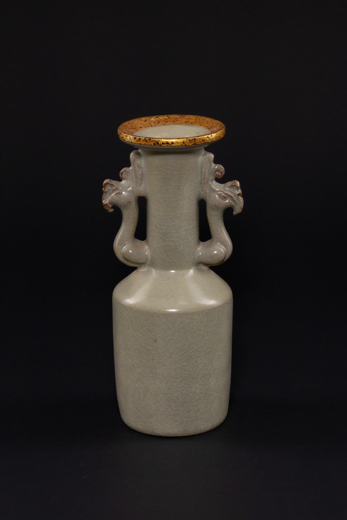 A CHINESE LONGQUAN CELADON PHOENIX-HANDLE MALLET VASE.: A rare Longquan celadon-glazed mallet vase, kinuta. The vessel is of characteristic form with a cylindrical body rising to a broad shoulder and a tall neck, flanked by a pair of handles moulded in the