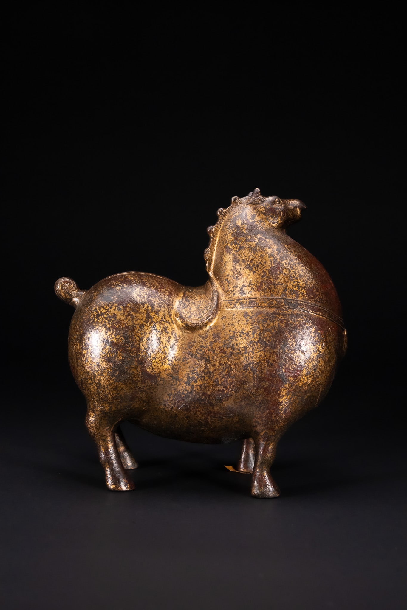 A CHINESE GILT-BRONZE FIGURE OF A STANDING HORSE. (1 of 5)