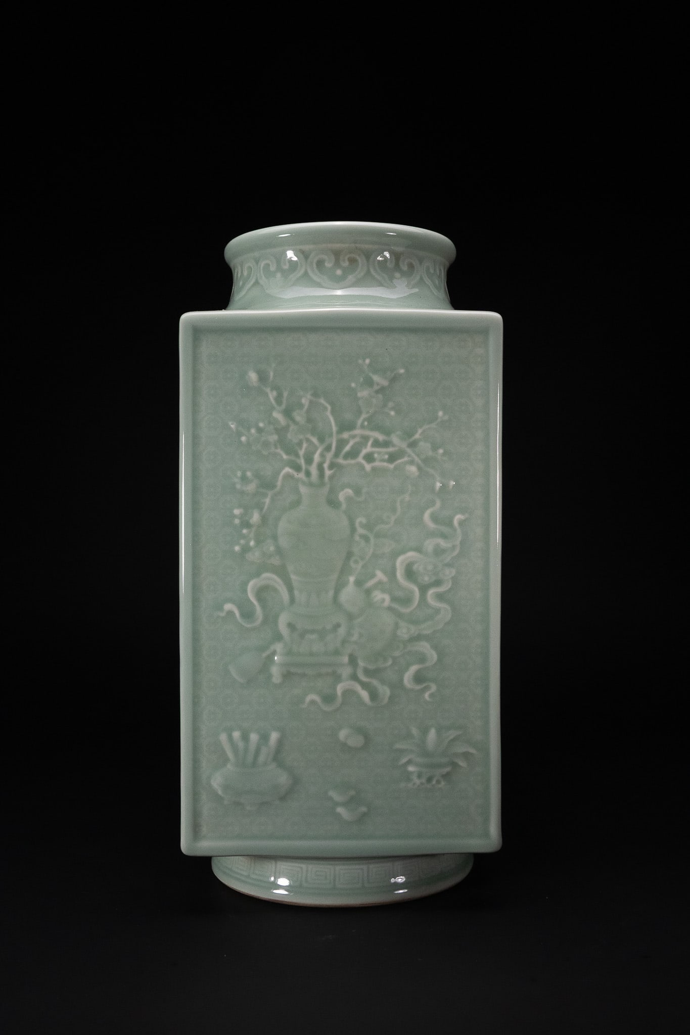 A CHINESE CELADON-GLAZED RELIEF-MOULDED RECTANGULAR CONG-FORM VASE, QIANLONG MARK. (1 of 3)