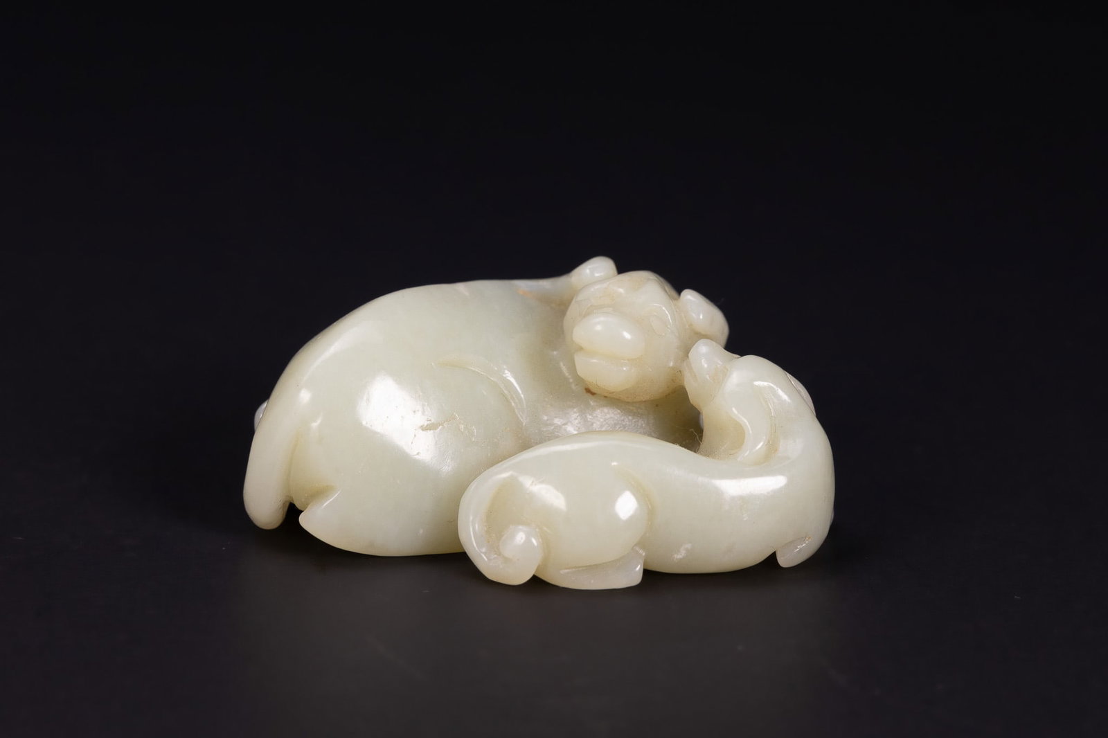 A CHINESE PALE CELADON JADE CARVING OF TWO MYTHICAL BEASTS. (1 of 4)