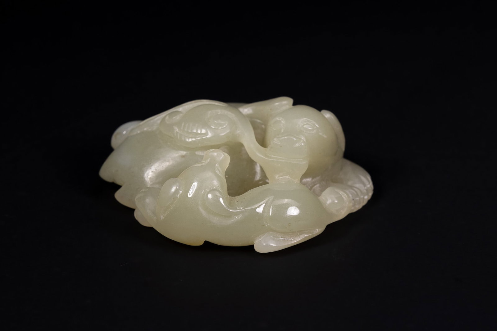A CHINESE CARVED PALE CELADON JADE GROUP OF A BOY AND MYTHICAL BEAST. (1 of 3)