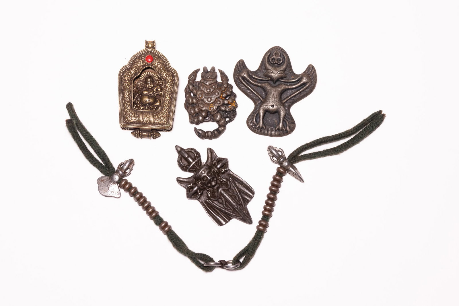 A COLLECTION OF FIVE TIBETAN RITUAL OBJECTS AND PROTECTIVE AMULETS. (1 of 3)