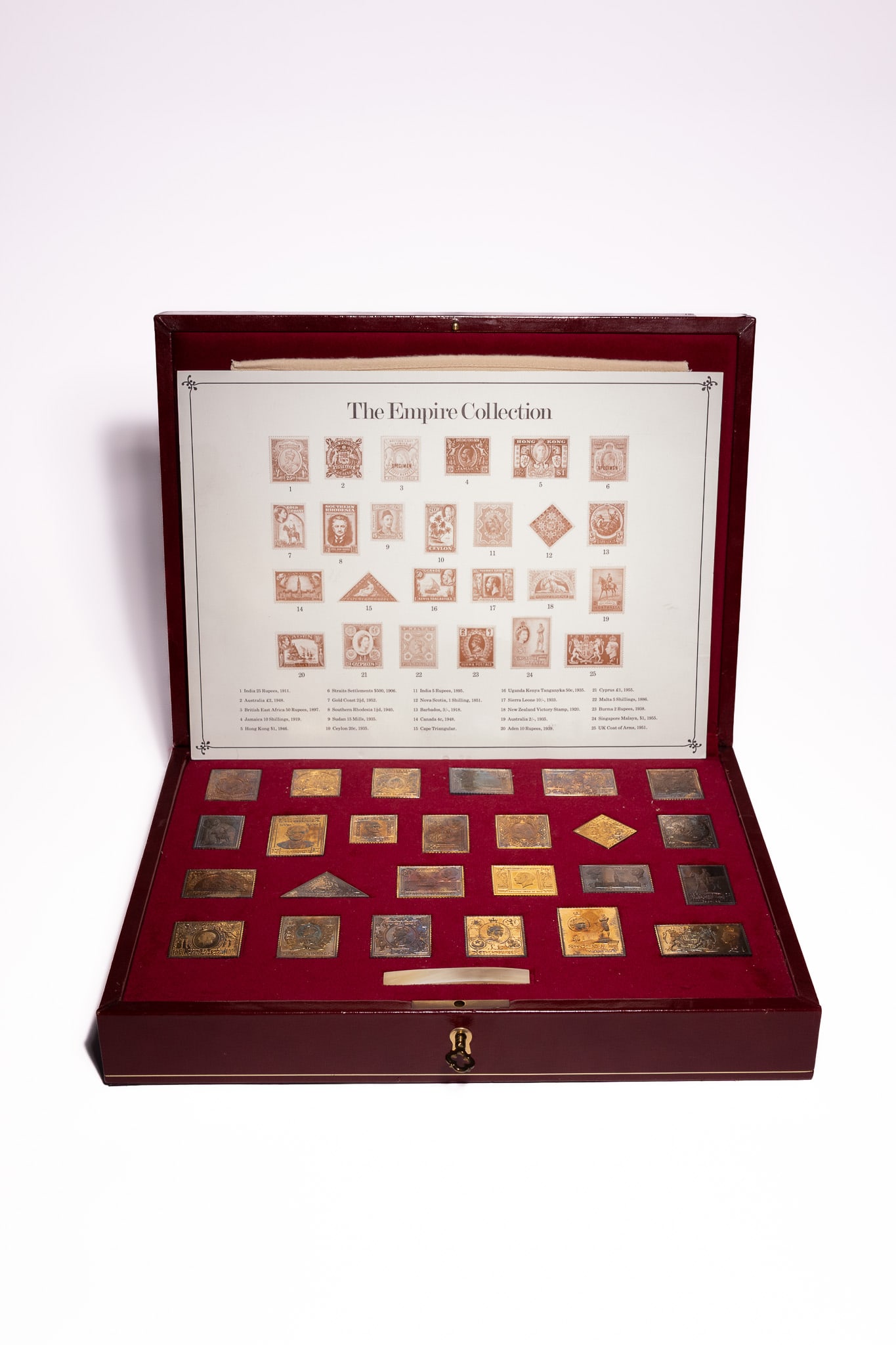 THE EMPIRE COLLECTION SILVER-GILT STAMPS SET, HALLMARK REPLICAS LTD, 1981.: A presentation set titled "The Empire Collection", comprising 25 gold-plated sterling silver (.925) stamp replicas, issued by Hallmark Replicas Ltd in 1981. Each stamp is finely detailed, depicting hi