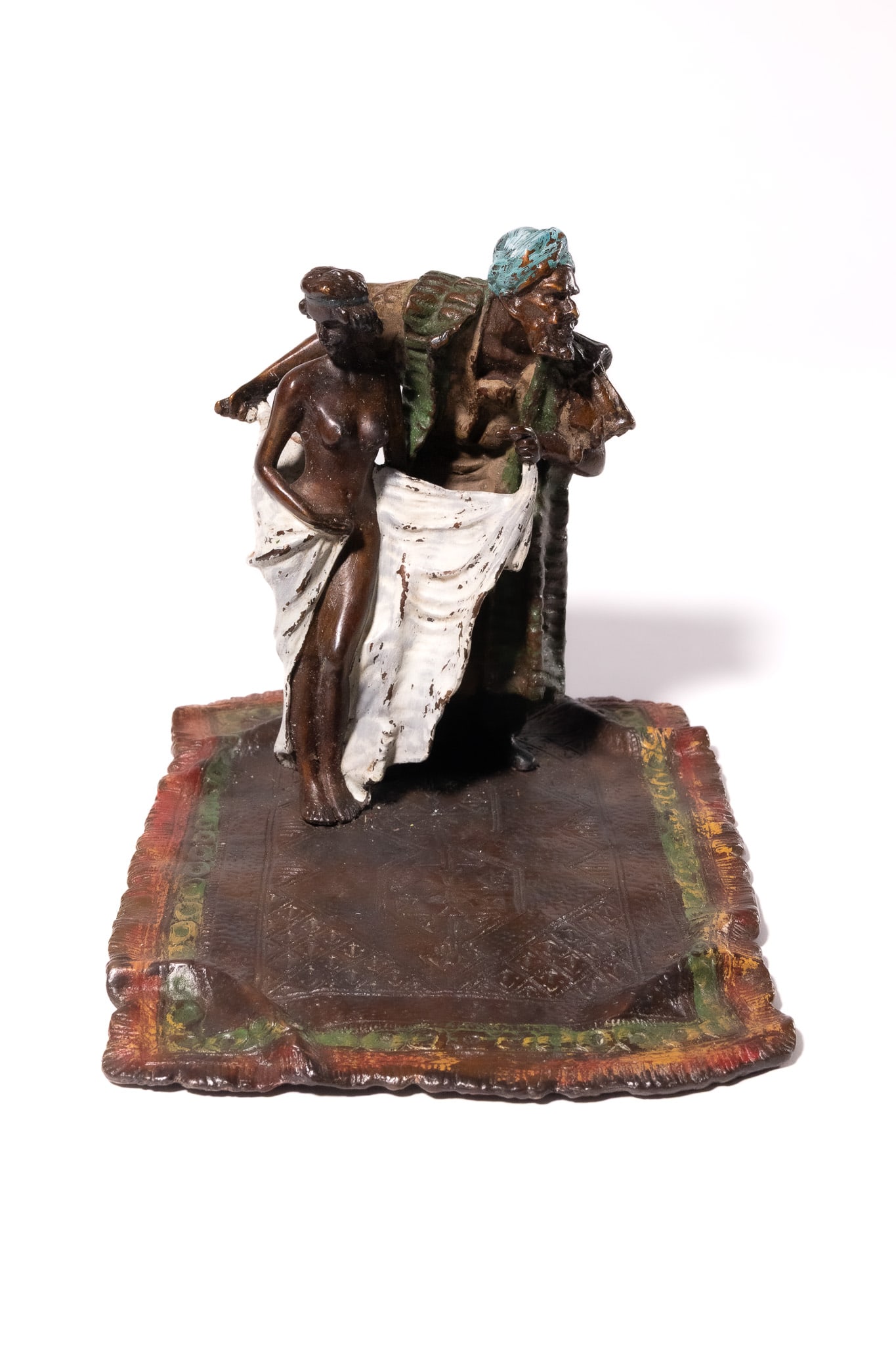 A LARGE COLD-PAINTED BRONZE FIGURAL GROUP OF AN ARAB CARPET SELLER AND A NUDE FEMALE. (1 of 4)
