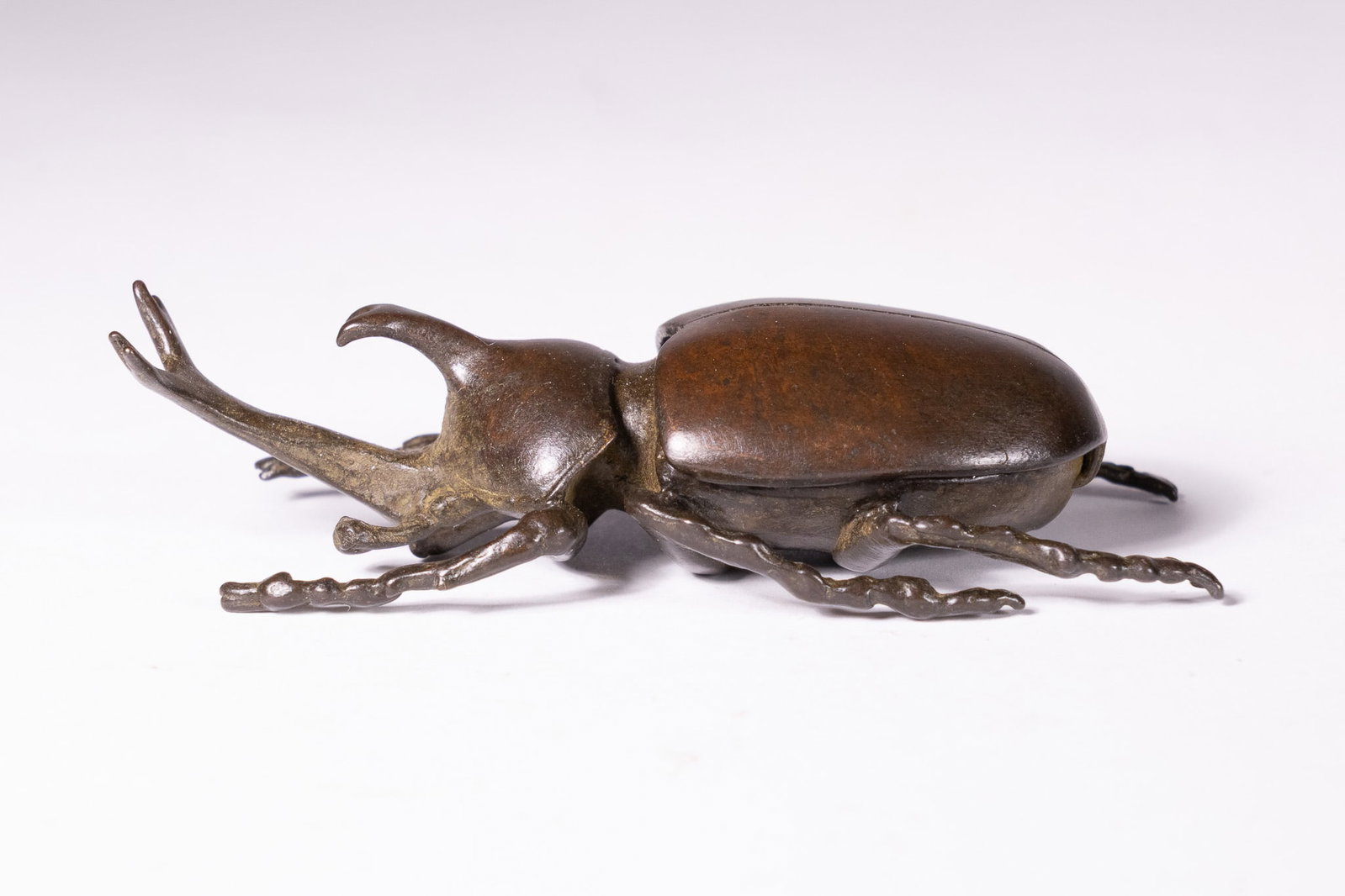 A JAPANESE BRONZE RHINOCEROS BEETLE OKIMONO LIDDED BOX. (1 of 5)