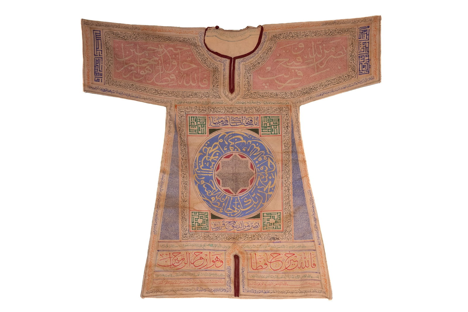 AN OTTOMAN TALISMANIC SHIRT WITH QURANIC CALLIGRAPHY AND GEOMETRIC MAGIC SQUARES, 19TH-20TH CENTURY.: A finely decorated textile talismanic shirt of traditional form, cut with wide sleeves and a central opening, entirely covered in intricate handwritten calligraphy and geometric designs. The surface i