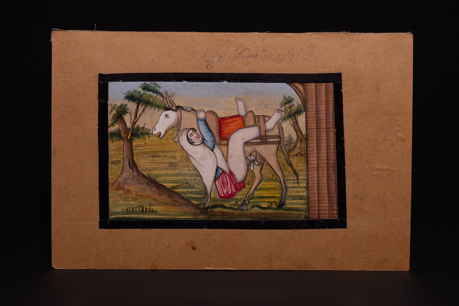 A QAJAR EROTIC MINIATURE PAINTING, 19TH CENTURY.: A Qajar erotic miniature painting executed in opaque watercolour and ink on paper, mounted on cardstock. The scene depicts a woman in a white chador, blue bodice, and red skirt in an inverted position