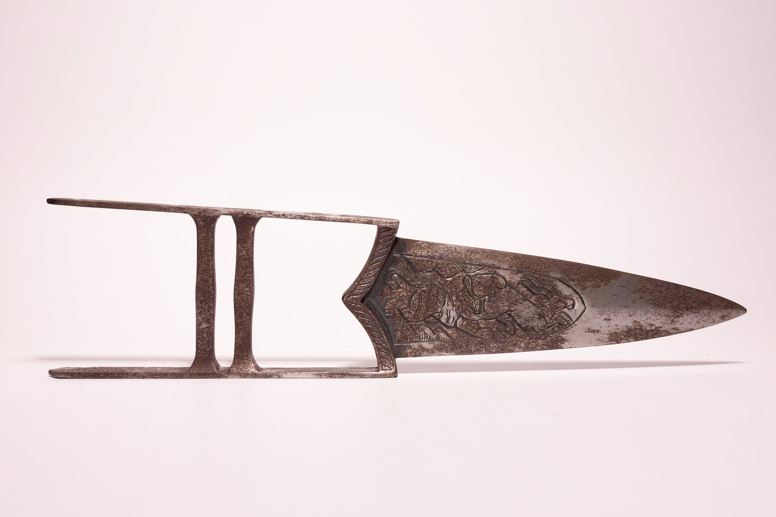AN INDIAN STEEL KATAR PUSH DAGGER.: A 19th-century Indian steel katar, or push dagger, of all-steel construction. The broad, triangular, double-edged blade tapers to a reinforced point. Both faces of the blade are decorated with detaile