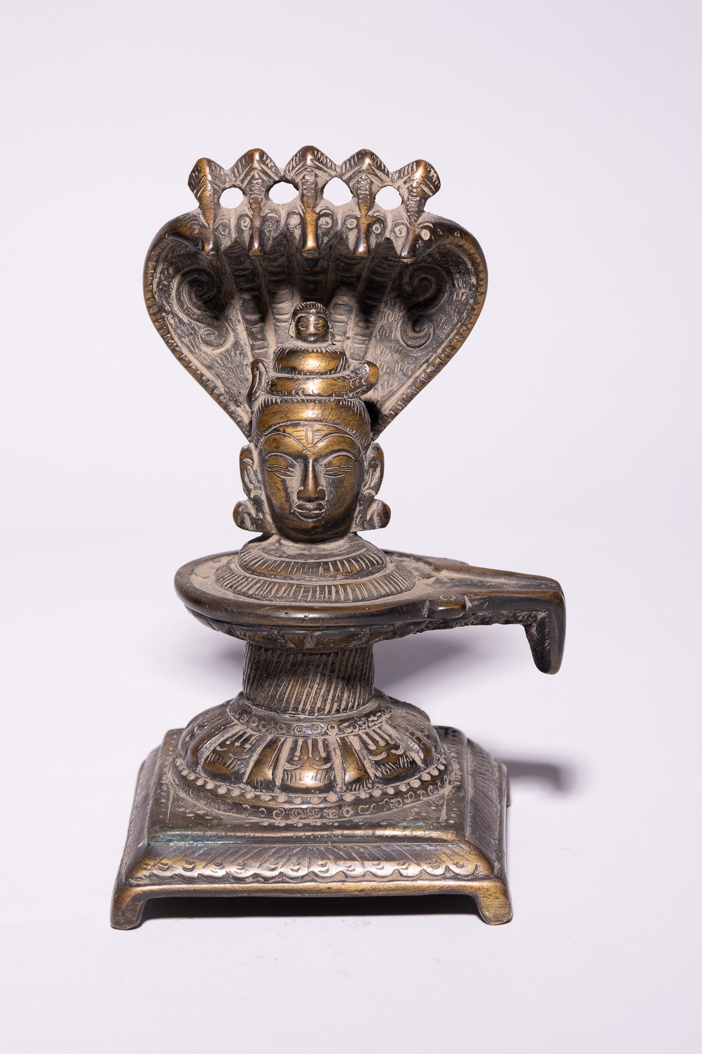 AN INDIAN BRONZE SHIVA LINGAM WITH NAGA CANOPY, 19TH CENTURY. (1 of 3)