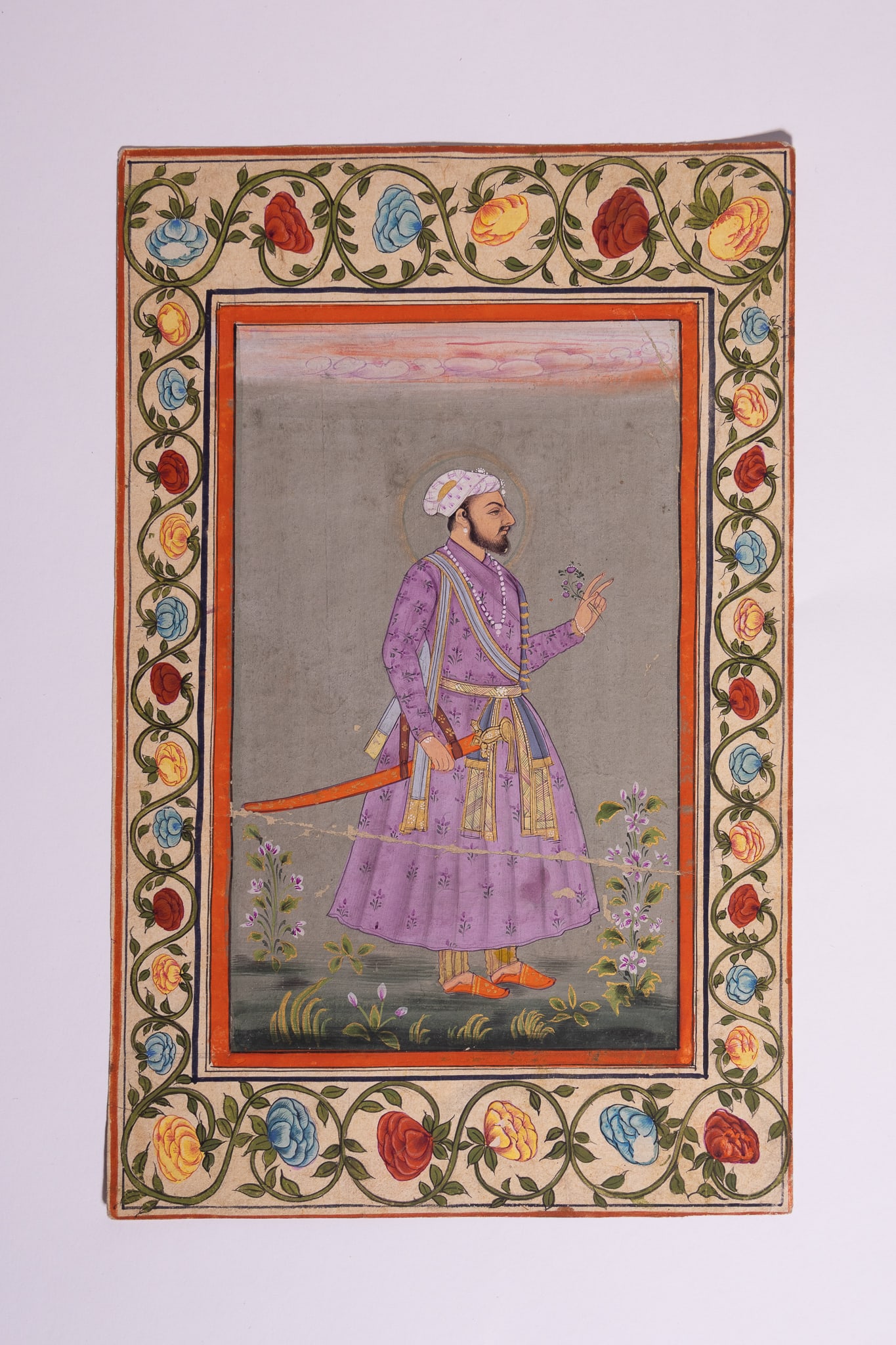 AN INDIAN MINIATURE PORTRAIT OF A MUGHAL EMPEROR, 18TH-19TH CENTURY.: An Indian miniature painting executed in opaque watercolour and gold on paper. The work depicts a full-length portrait of a Mughal emperor or royal figure shown in profile facing right. The subject is
