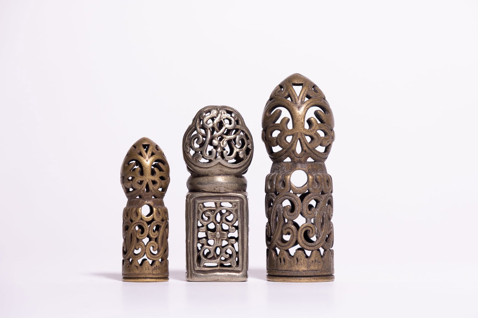 A TRIO OF SINO-TIBETAN CAST METAL PIERCED OPENWORK PERSONAL SEALS. (1 of 2)