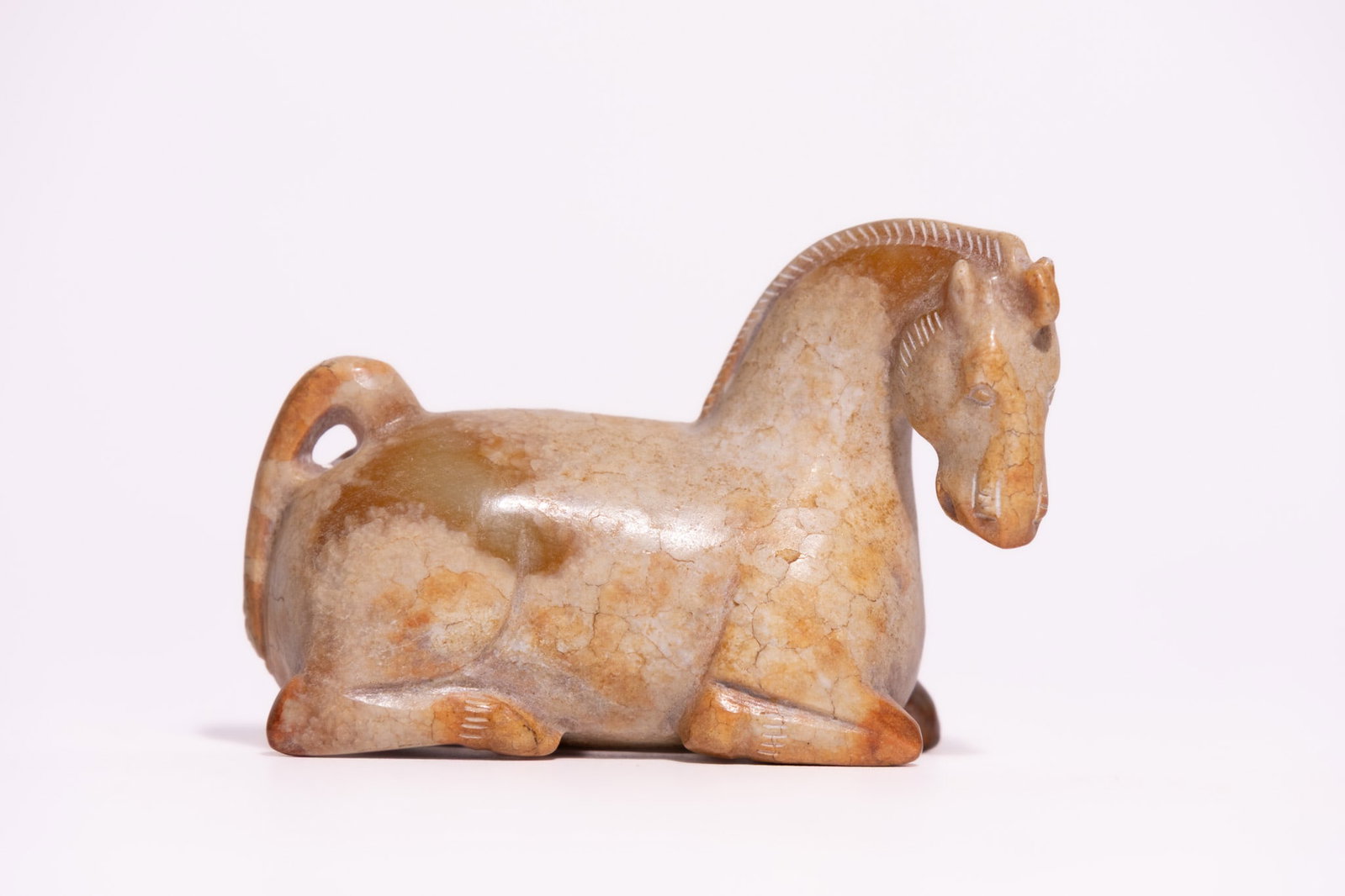 A CHINESE ARCHAIC STYLE CARVED JADE FIGURE OF A RECUMBENT HORSE. (1 of 4)