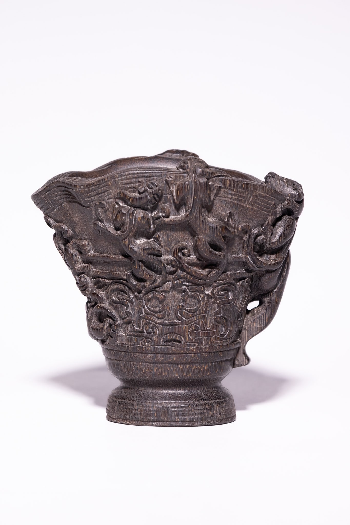 A CHINESE LIBATION CUP WITH HIGH-RELIEF MYTHICAL BEAST DECORATION. (1 of 7)
