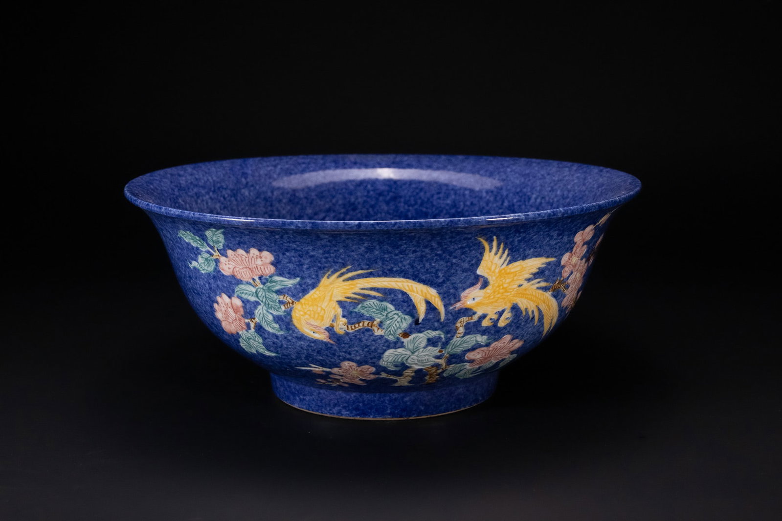 A CHINESE POWDER-BLUE GROUND FAMILLE ROSE PORCELAIN BOWL, MING MARK.: A Chinese porcelain bowl of deep form with a widely flared rim, supported on a short straight foot. The exterior and interior surfaces are decorated with a mottled cobalt-blue glaze, known as powder b