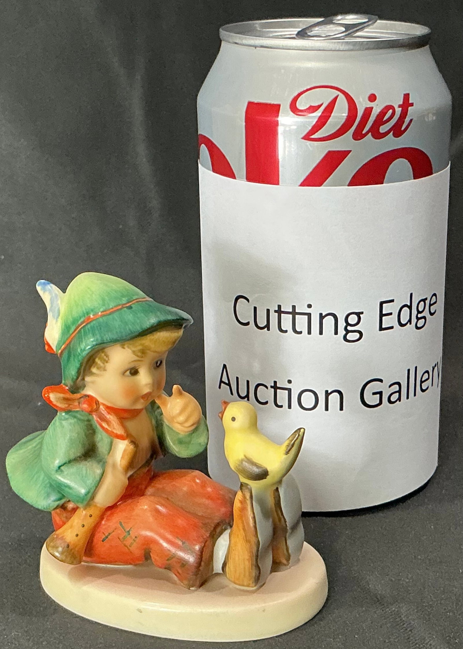 Vintage Goebel Hummel "Whistler’s Boy" Figurine Hum 63, W. Germany: Charming vintage Goebel Hummel figurine titled "Whistler’s Boy", model Hum 63. Depicts a young boy in a green cap and red trousers, seated on a fence post while whistling to a small yellow bird perc