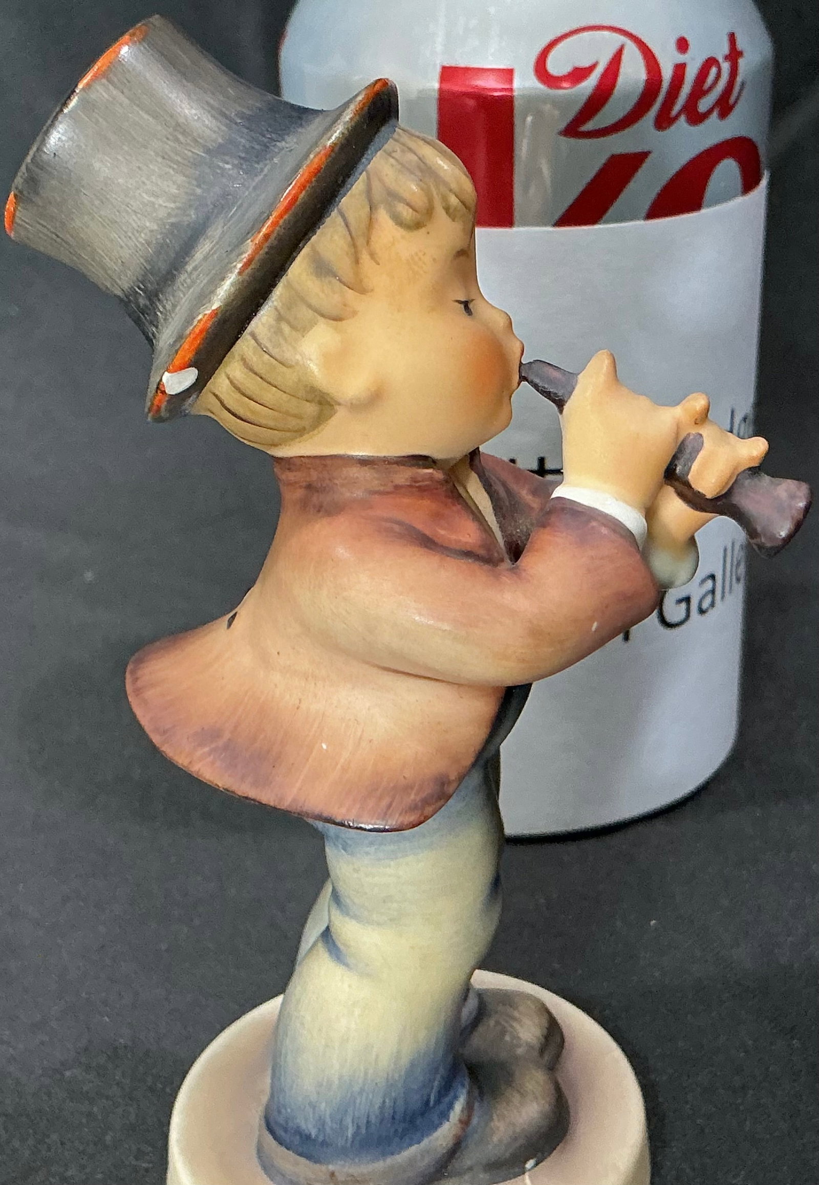 Goebel Hummel "Serenade" Figurine Hum 85, W. Germany: Charming vintage Goebel Hummel figurine titled "Serenade", model Hum 85. Depicts a young boy in a tall hat and coat, playing a flute with delightful concentration. The piece captures Hummel’s signat