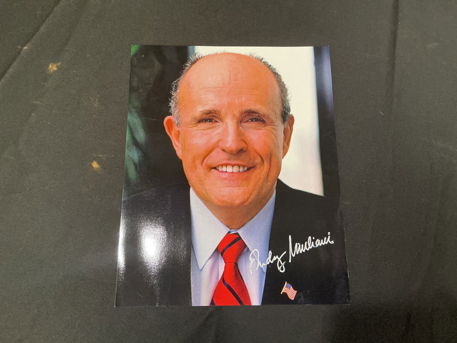 Signed Color Portrait Photograph of New York City Mayor Rudy Giuliani: Glossy 8x10 color portrait of Rudolph W. Giuliani signed in metallic silver “Rudy Giuliani”.