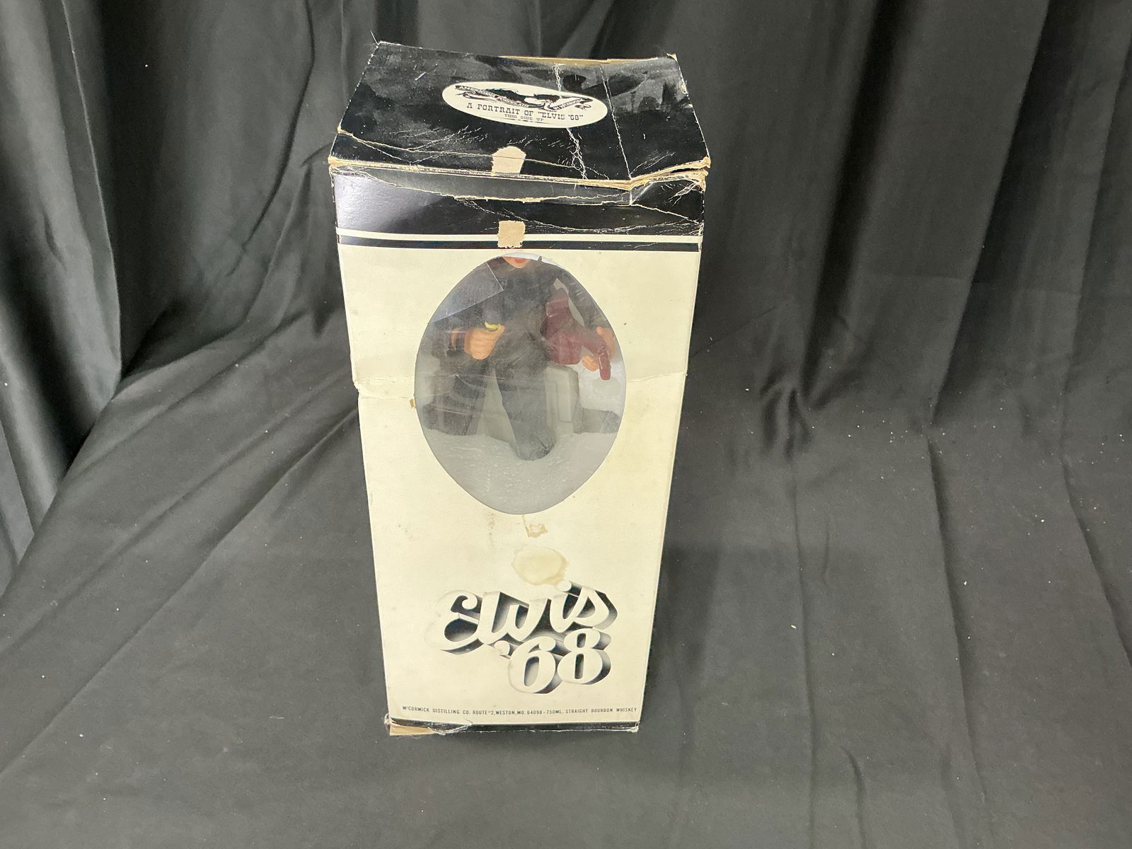 Elvis '68 Americana Porcelain Decanter with Original Box: Americana Porcelain decanter titled “Elvis ’68,” depicting Elvis Presley in his iconic black leather ensemble from the 1968 television comeback special. Produced by McCormick Distilling Co.