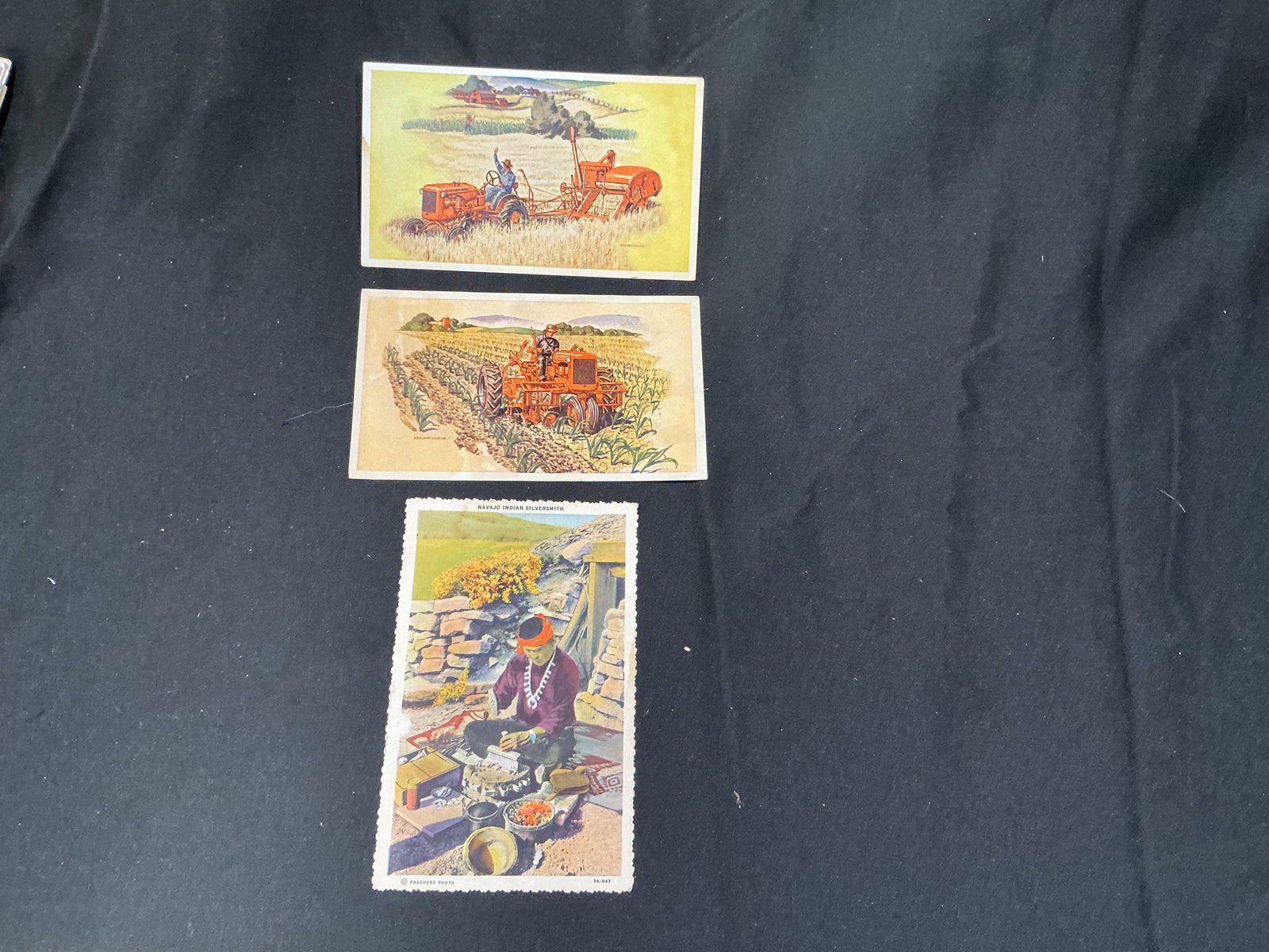Group of 3 Vintage Postcards International Harvester Advertising & Navajo Indian Blueberry Scene: Group of three vintage postcards, including two International Harvester advertising cards depicting classic 1940s farm tractor scenes, and one Navajo Indian Blueberry postcard showing a Southwestern N