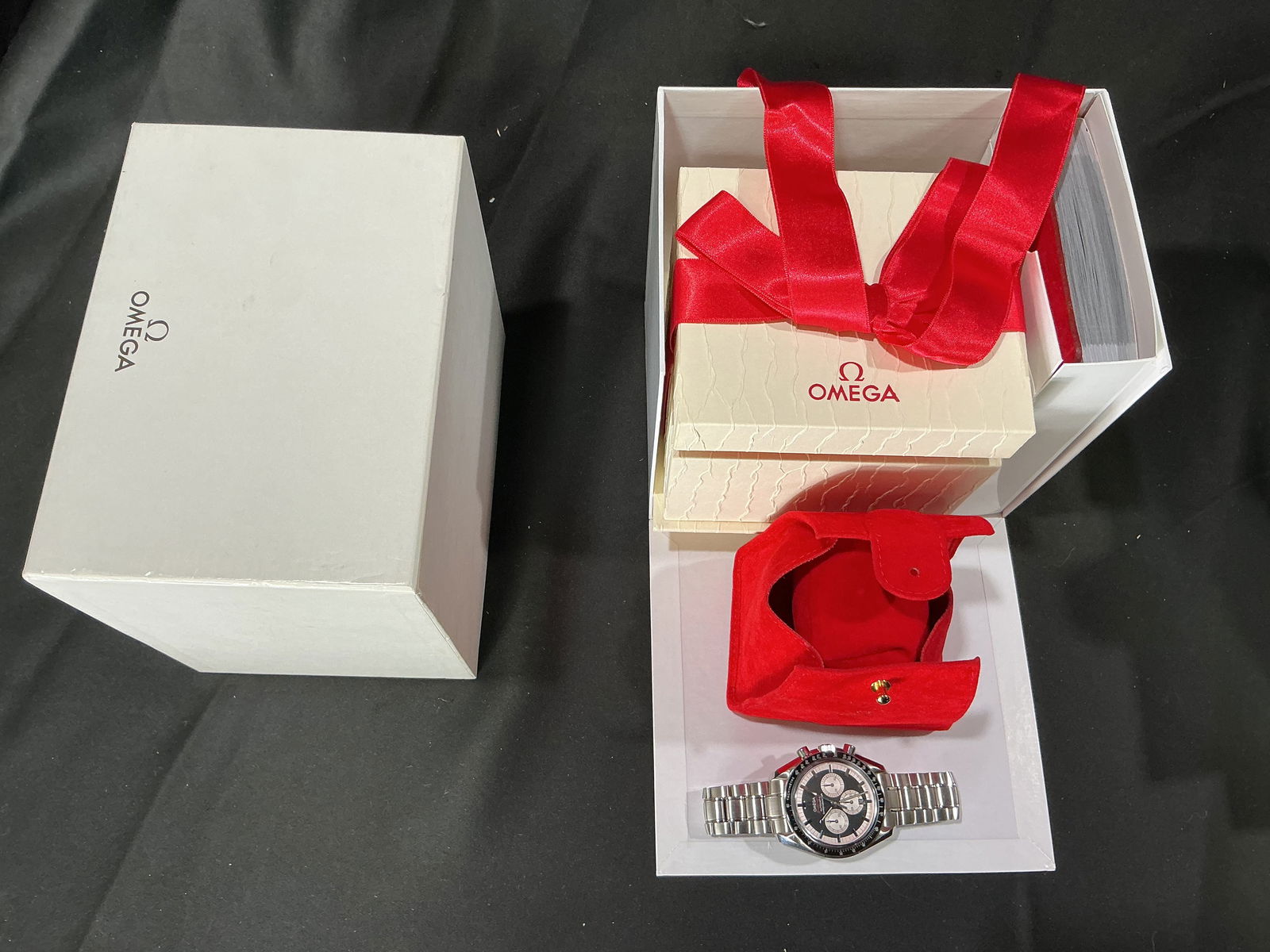 Unworn Omega Speedmaster Professional Chronograph Wristwatch with Box and Papers: Omega Speedmaster Professional automatic chronograph wristwatch featuring a black dial with three subdials, tachymeter bezel, stainless steel case, and stainless steel bracelet. Accompanied by origina