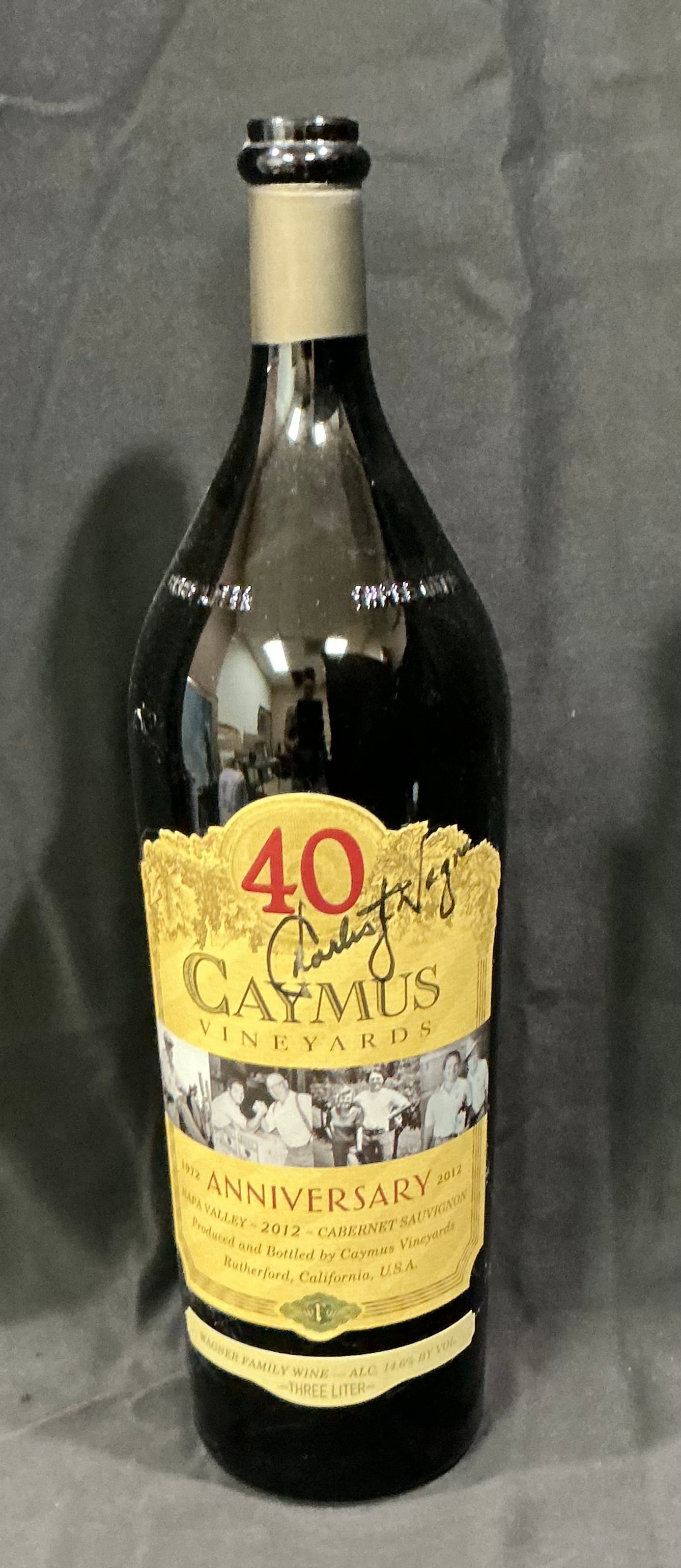 Caymus Vineyards 40th Anniversary Cabernet Sauvignon 2012 Empty Display Bottle: Caymus Vineyards 40th Anniversary Cabernet Sauvignon (2012) glass bottle. This is an **empty** collectible display bottle featuring the gold embossed 40th anniversary label and winery history artwork.