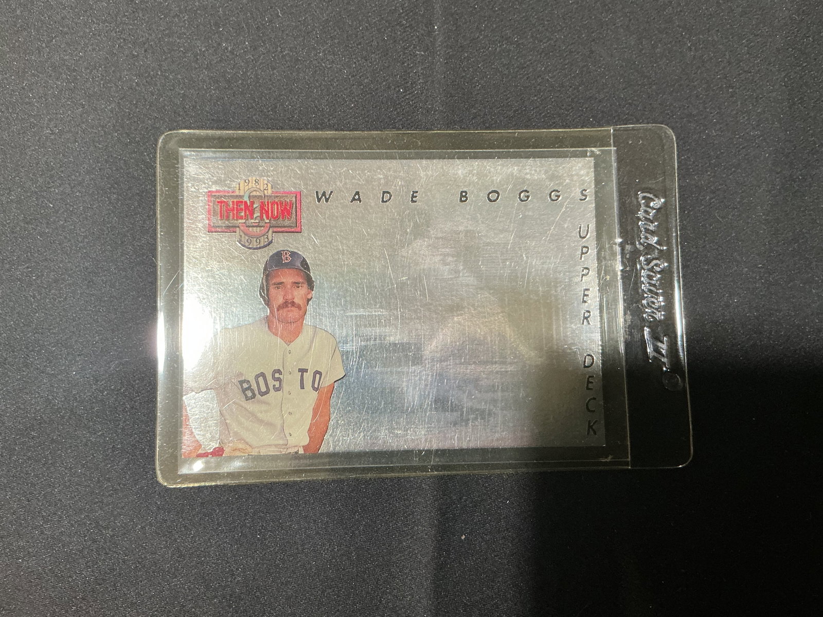 Upper Deck Then and Now Wade Boggs Baseball Card: Upper Deck 'Then and Now' Wade Boggs baseball card, commemorating career highlights. Housed in protective sleeve. Shows surface wear to holder.